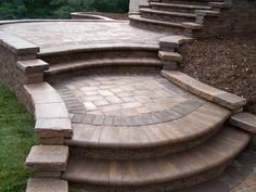 an outdoor patio with steps and landscaping