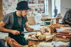 a man is cutting meat on a table