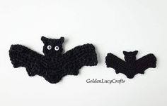 two crocheted bats sitting next to each other