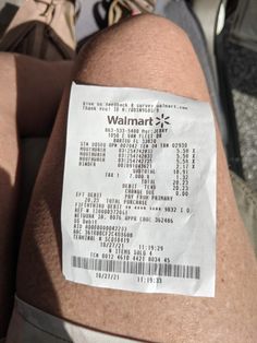 a person's leg with a receipt on it that says walmart 2k