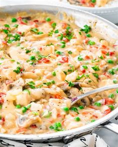 a pan filled with chicken and vegetable casserole on top of a white table