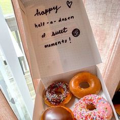 there are four donuts in the box and one is happy half - a - dozen of sweet moments