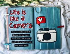 an open book with the words life is like a camera