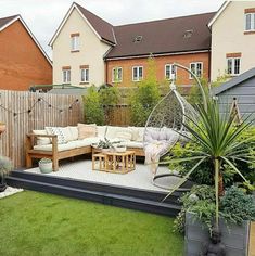 an outdoor living area with couches, tables and potted plants