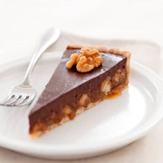 a piece of chocolate pie on a plate with a fork