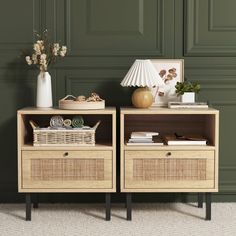 two wicker baskets sit on top of an end table next to a lamp and vase