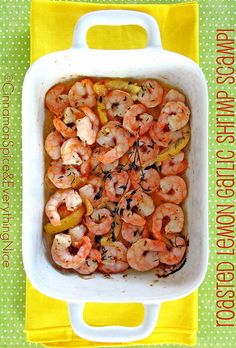 a casserole dish with shrimp and vegetables in it on a yellow napkin next to a green polka dot towel