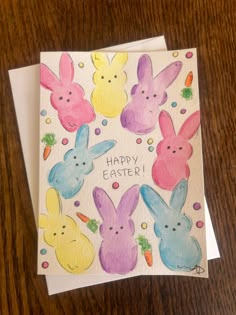 an easter card with bunny ears and carrots in the center on a wooden table