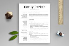 a professional resume template on top of a desk next to a ruler, pencil and pen