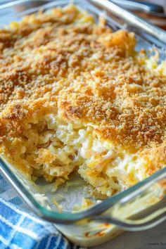 a casserole dish filled with macaroni and cheese on a blue checkered cloth