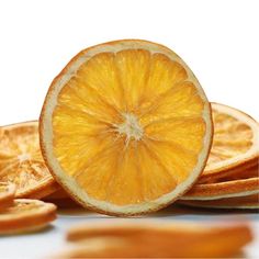 an orange cut in half sitting on top of other slices