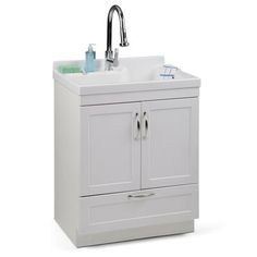 a white bathroom sink sitting under a faucet next to a cabinet with drawers