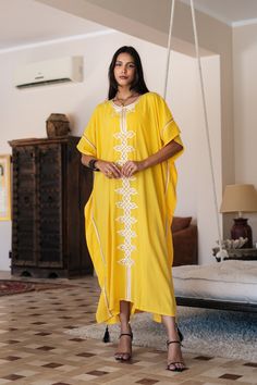 **Note : The kaftan in the video is a different color of the same kaftan and is shown to display the cut, fit, and fabric. You will receive the kaftan in the pictures.** An elegant Moroccan caftan will make you feel like African royalty. It's extremely elegant with a dash of classy cotton embroidery in the front. Ideal for plus size women as well. Made of extremely soft fabric to make you feel free and beautiful at the same time.  This Kaftan is ideal to wear for any casual occasion. Whether tak Summer Cotton Dresses With Dabka Detailing, Summer Maxi Length Dress With Dabka Detailing, Summer Maxi Dress With Dabka Detail, Summer Maxi Dress With Dabka Embroidery, Yellow Embroidered Kurta For Summer, Yellow Embroidered Summer Kurta, Summer Yellow Embroidered Kurta, Free Size Tunic Abaya, Yellow Embroidered Summer Kaftan