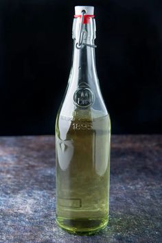 a glass bottle filled with liquid sitting on top of a table