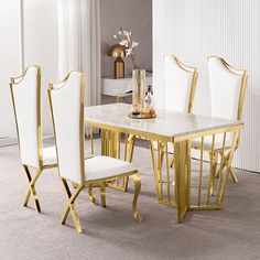 a white and gold dining table with chairs