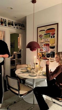 two women sitting at a table with wine glasses