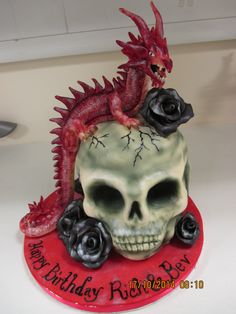 there is a skull with a dragon on it and roses in the middle of it