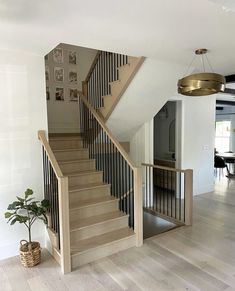 the stairs are made of wood and have metal balustiers on each handrail