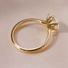 a gold ring with a diamond on it