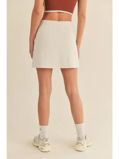 Your new go to tennis skirt is here and ready to be worn for all of your fave Summer activities! - Features a smoothing shape high waist as well as built in short lining. - Fits true to size | Model is 5'9" wearing a size Small - INSEAM S - 14.25" M - 14.5" L - 15" - 75%, Nylon, 25% Spandex *due to screens / filters colors may vary slightly to photos*