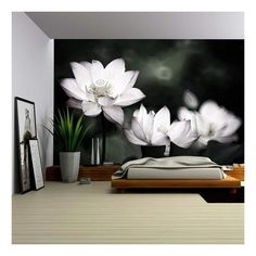 a bedroom with white flowers on the wall