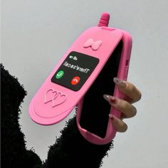 a person holding a pink cell phone in their hand