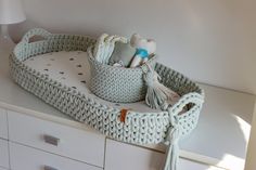 a crocheted basket on top of a dresser