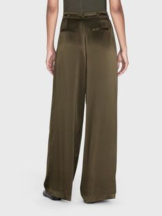 A 100% silk high rise, wide-leg trouser with front center pleats for a dramatic silhouette that drapes beautifully. Featuring a skinny waist tie for an adjustable fit and side and back pockets. High Rise FitDry Clean Only100% Silk13.25" Front Rise/32" Inseam/28.5" Leg Opening Dramatic Silhouette, Pleat Dress, Silk Trousers, Menswear Inspired, Guinea Bissau, Turks And Caicos Islands, Military Green, Pleated Dress, Waist Tie