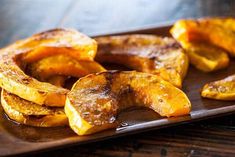 grilled bananas are on a wooden plate