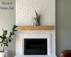 a living room with a white brick fireplace and potted plants on the mantel