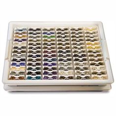 a tray filled with lots of different colored beads