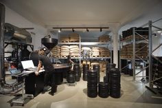 a man working in a large room filled with barrels