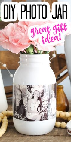 a vase filled with pink flowers sitting on top of a table next to other items