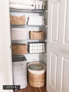 an organized closet with baskets and towels