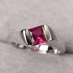 ◆ The ring is handcrafted from sterling silver and decorated with a dazzling 6*6 mm ruby. It is suitable for engagement/anniversary/daily occasion. ◆ Production Description: Main stone Type: Lab Ruby Main Stone Shape: Princess Cut Main Stone Size: 6*6 mm (1.38ct) Side stone: None Metal: 925 Sterling silver - Other options available in the drop down menu ◆ Customization: √Free for Add Engraving √Other Metal Type Available √Other Gemstones & Shapes Available √Personalization Requests Available Modern Round Cut Ruby Ring For Anniversary, Classic Ruby Birthstone Promise Ring, Gift Ruby Ring With Center Stone, Modern White Gold Ruby Ring For Anniversary, Classic Ruby Ring With Tension Setting For Gift, Ruby Solitaire Birthstone Ring For Promise, Classic Ruby Ring With Tension Setting As Gift, Ruby Ring With Center Stone For Anniversary, Formal Lab-created Ruby Diamond Ring With Birthstone