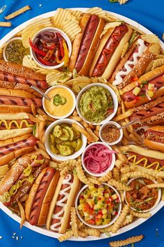 a platter filled with hot dogs and condiments