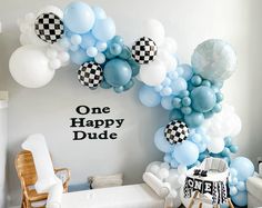 a room decorated with balloons and decorations for a one happy dude themed birthday party at home