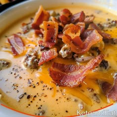 a bowl of soup with bacon and cheese