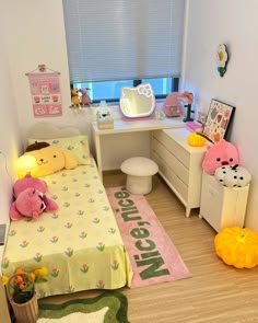 a small bedroom with teddy bears on the bed