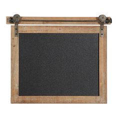 an old wooden frame holds a chalkboard and two metal straps on the bottom half of it