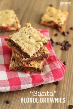 three brownies stacked on top of each other with chocolate chips scattered around them and the words santa blondie brownies written below