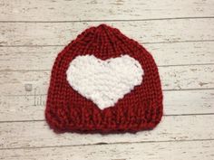 a knitted hat with a white heart on it