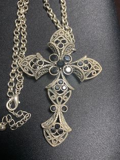 "Vintage base metal ornate cross necklace.  Black stones set in a filagree cross.  Cross is 3\" high, 2\" across.  Total length of chain is 18\" with a 2 adjustable length lobster closure." Bohemian Cross Metal Jewelry, Bohemian Metal Cross Jewelry, Vintage Metal Cross Necklace, Ornate Cross Necklace With Intricate Design, Black Bohemian Cross Jewelry, Bohemian Black Cross Jewelry, Costume Jewelry Metal Cross Pendant, Costume Jewelry Cross In Metal, Adjustable Metal Cross Necklace