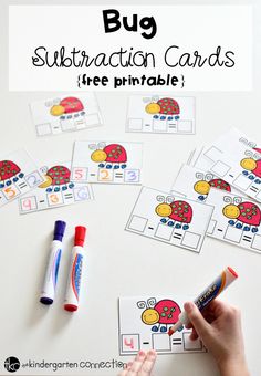 a hand holding a marker and writing on a piece of paper with the words bug subtraction cards