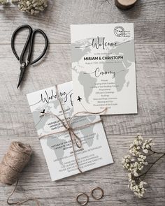 the wedding stationery is laid out next to some scissors and twined twine