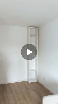 an empty living room with white walls and wood flooring is featured in this video