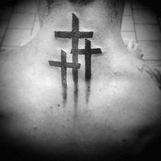 the back of a man's neck with crosses on it