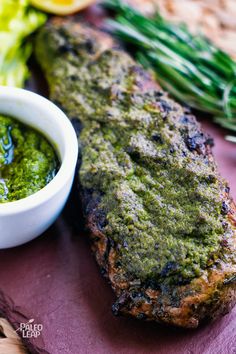 grilled steak with pesto sauce on the side