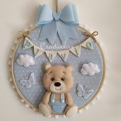 a teddy bear hanging from the side of a wall with a blue ribbon around it