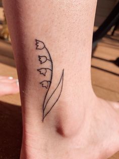 a woman's foot with a tattoo on it